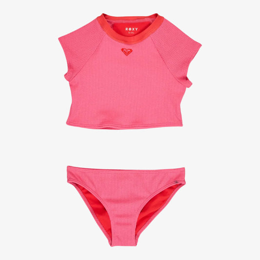 Pink two-piece swimsuit with Roxy logo on a white background